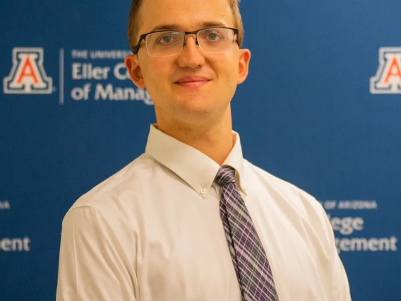 A young man smiling at the camera.