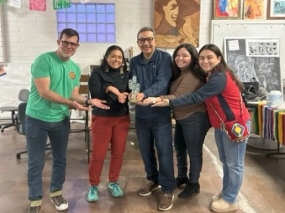 Group of people holding an award