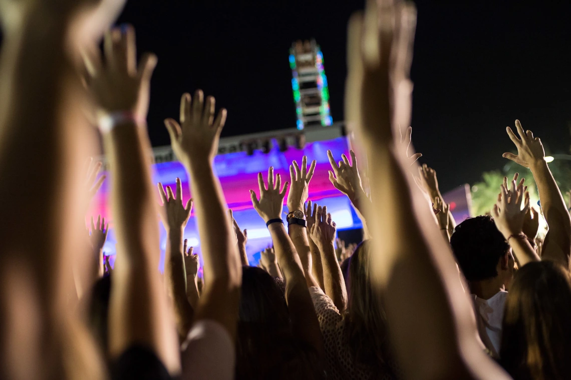 At an event with hands in the air