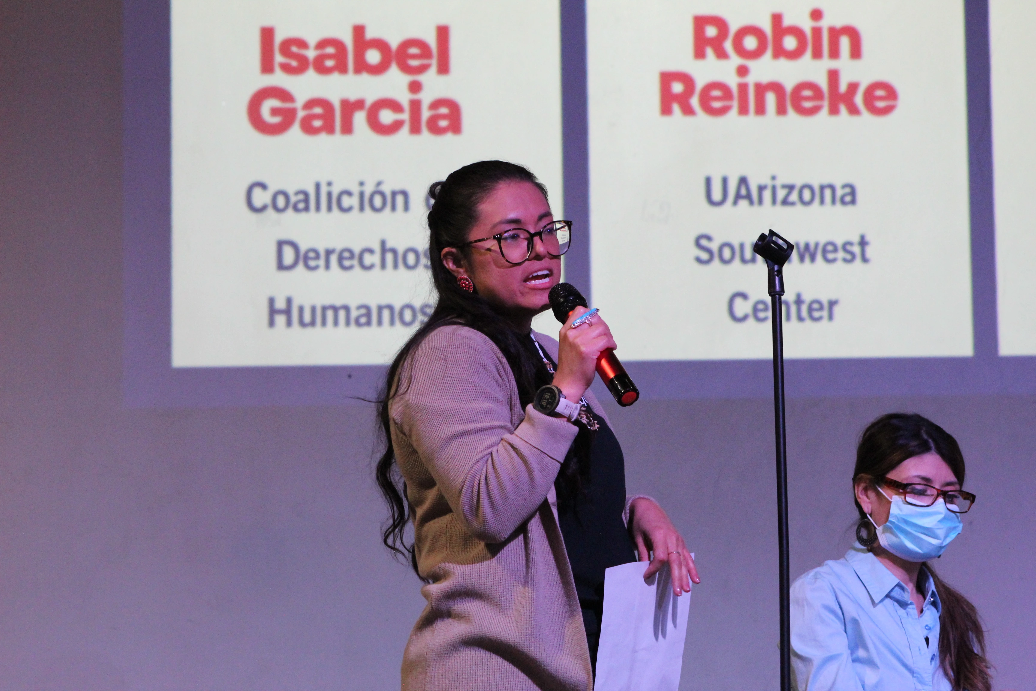 Women talking to a crown using a microphone