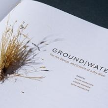 image of the word groundwater on some paper with some brown grass 