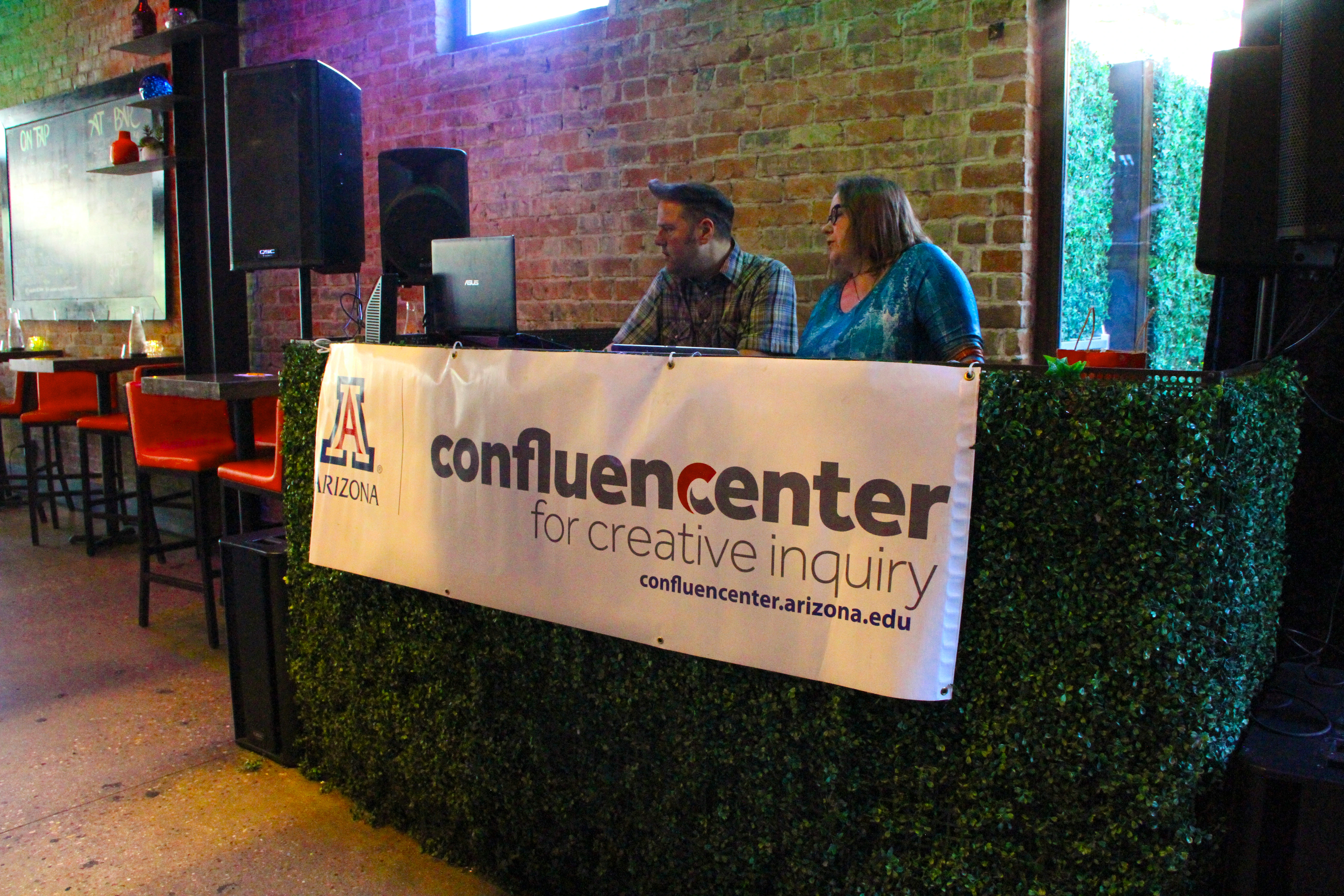 Three panel members sitting at a table with a Confluencenter table banner.
